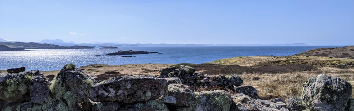 Image of a wall on an island in Scotland and blue skies